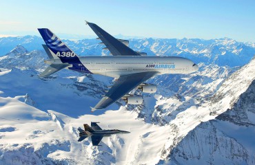 The A380 in flight with fighter jet at wing