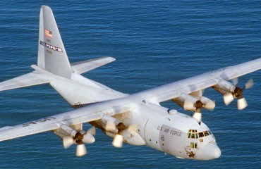 Lockheed C-130 Hercules flying over water